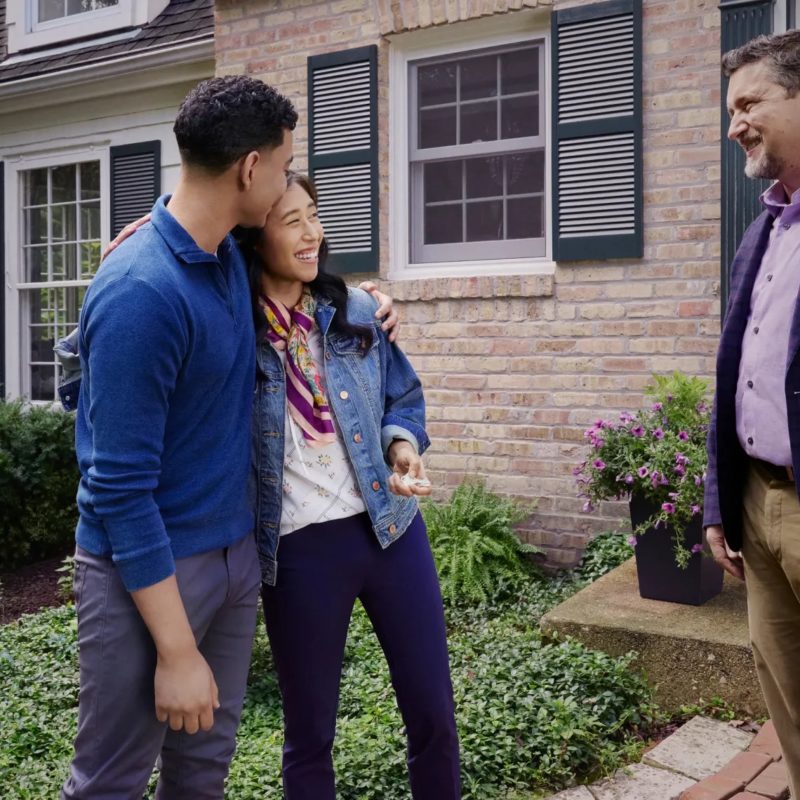 Happy family holding keys to their new suburban house purchased through first-time home buyer programs Texas in 2026.