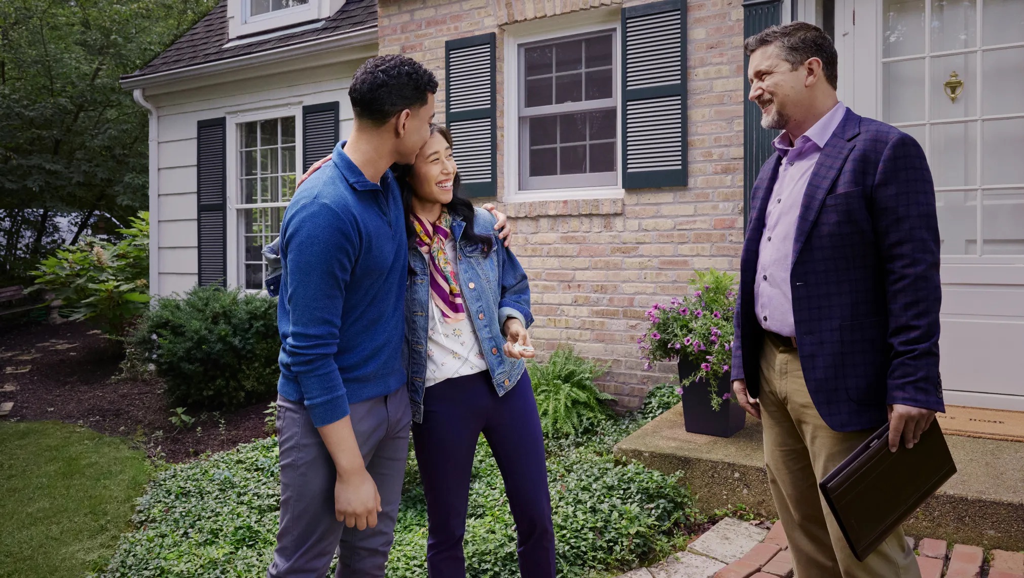 Happy family holding keys to their new suburban house purchased through first-time home buyer programs Texas in 2026.
